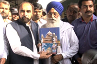 Chairman Evacuee Trust Property Board Siddiq ul Farooq presenting a book The Sikh Heritage of Pakistan to Leader of delegation of Indian Sikh Pilgrims came to attend Jor Mela.
